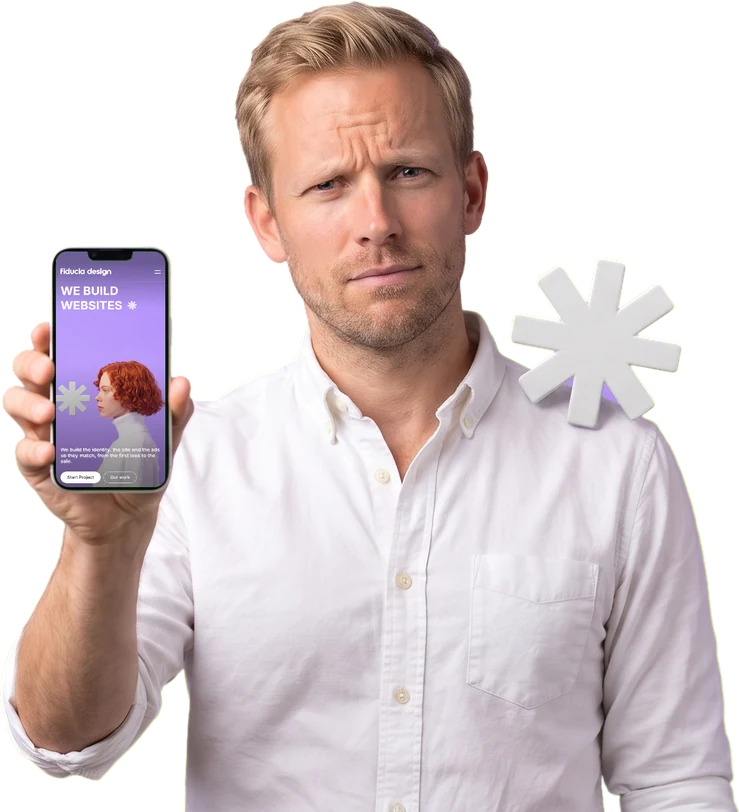 A man frowns at his phone, against a purple background.