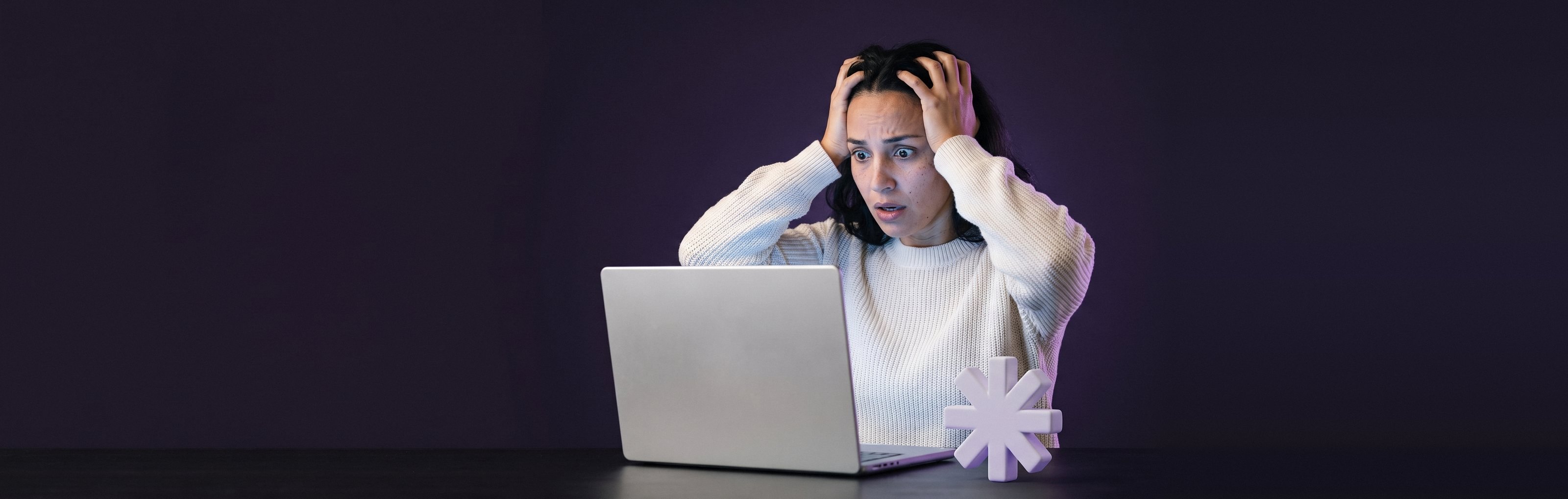 A woman smiles at her laptop showing a Site secure message.